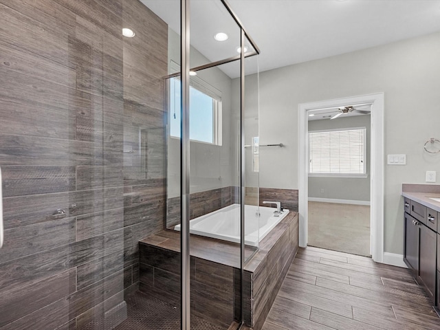 302 Eado Park Cir, Houston, TX 77020 - full bath with vanity, a stall shower, a bath, and wood finished floors