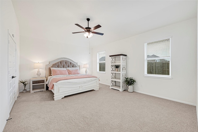 carpeted bedroom featuring baseboards and a ceiling fan