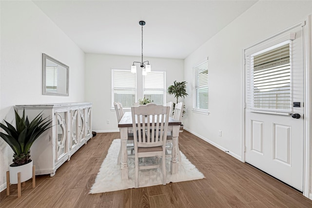 dining room featuring baseboards and wood finished floors