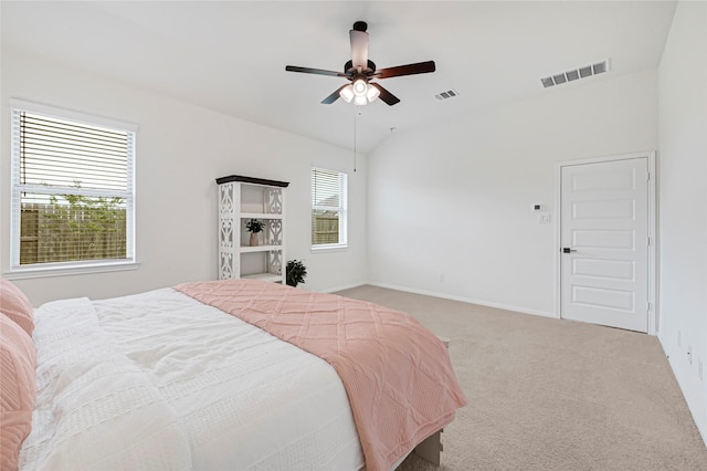 bedroom featuring ceiling fan, light colored carpet, lofted ceiling, and visible vents