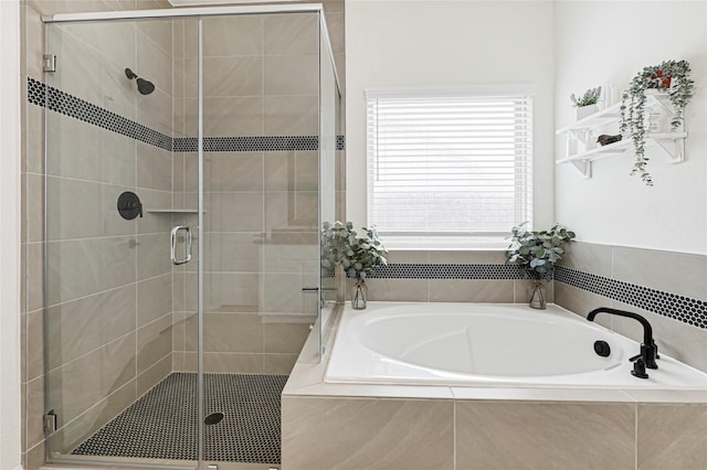 bathroom with a garden tub and a stall shower