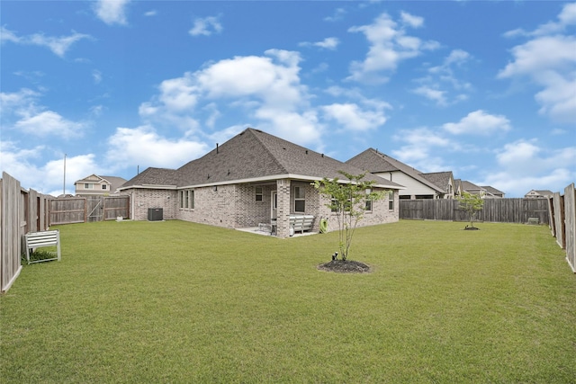 view of yard with central AC, a fenced backyard, and a patio area