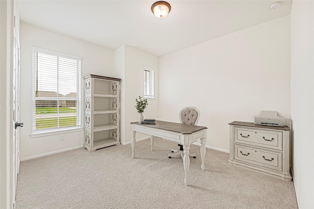 home office featuring carpet floors, baseboards, and plenty of natural light
