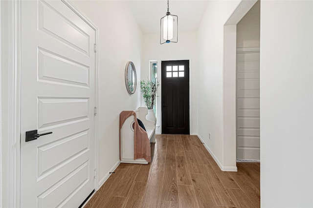 interior space featuring baseboards and wood finished floors
