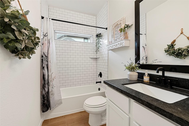 full bath featuring shower / bath combo with shower curtain, toilet, wood finished floors, and vanity