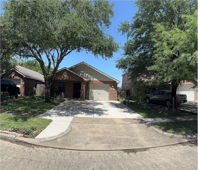 view of front of property with an attached garage, concrete driveway, and brick siding