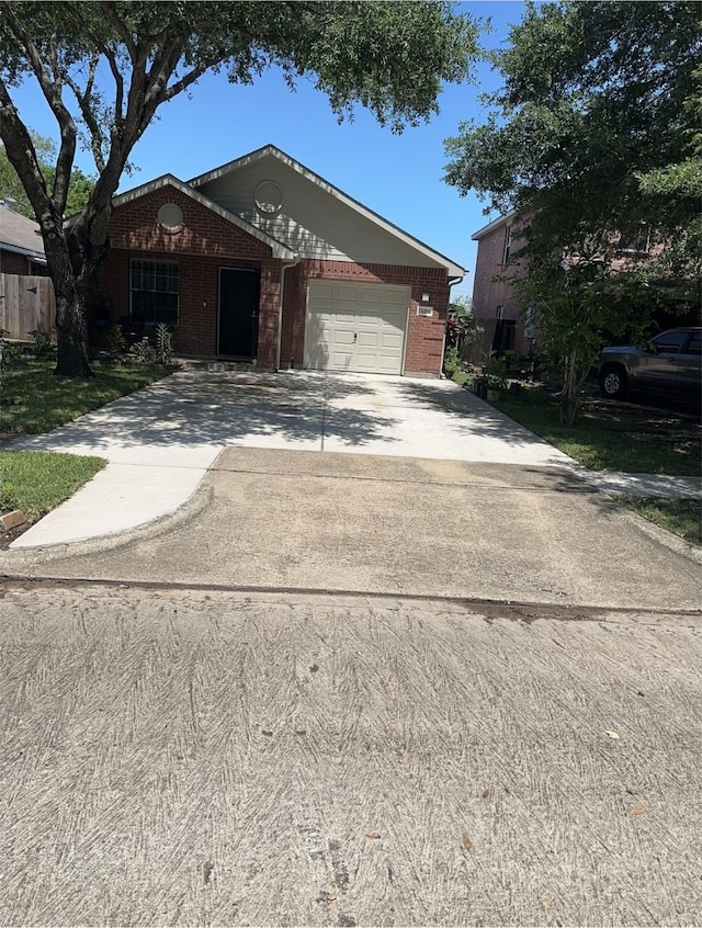 ranch-style home with brick siding, a garage, and driveway