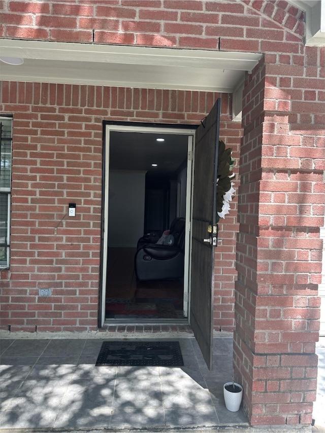 property entrance with brick siding