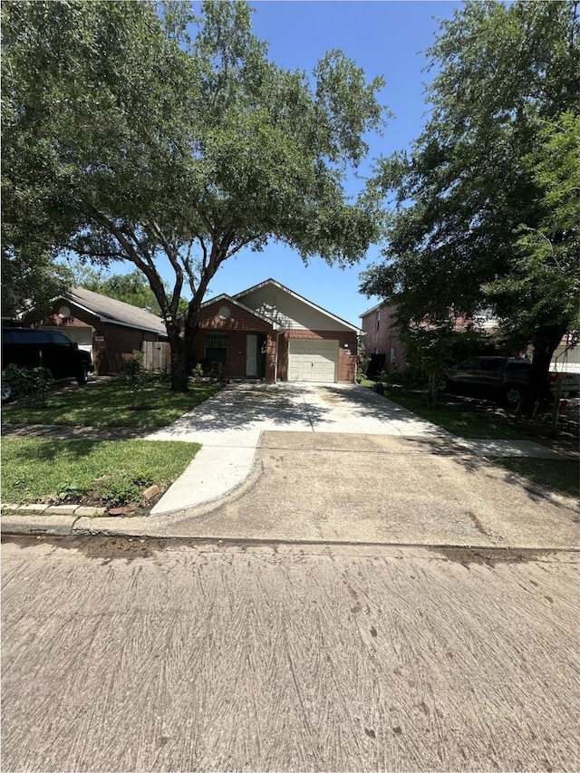 ranch-style house with an attached garage, brick siding, and concrete driveway