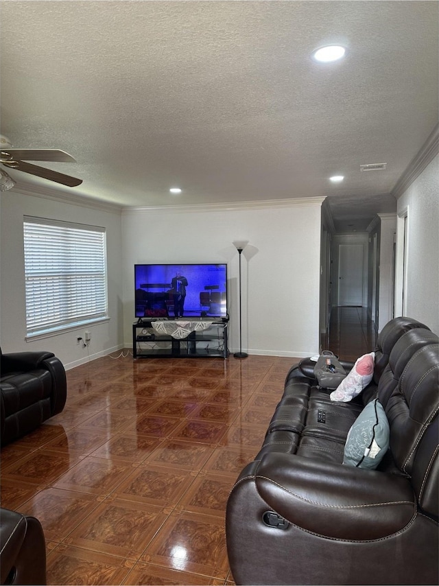living room with crown molding, a ceiling fan, a textured ceiling, and visible vents