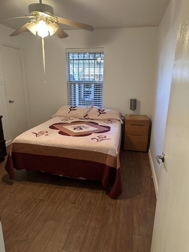 bedroom with ceiling fan and dark wood finished floors
