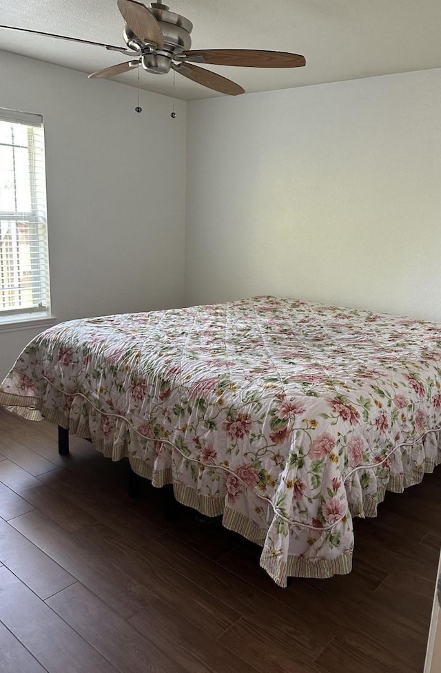 bedroom with a ceiling fan and wood finished floors