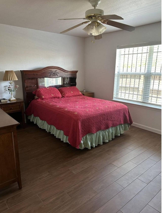 bedroom featuring baseboards, ceiling fan, and wood finished floors