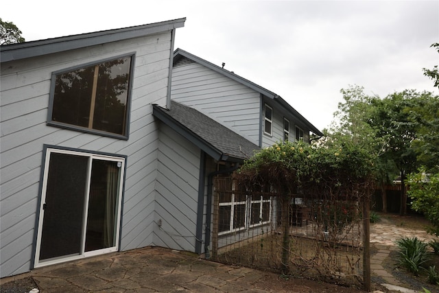 1035 Wirt Rd, Houston, TX 77055 - back of property featuring a patio, a shingled roof, and fence