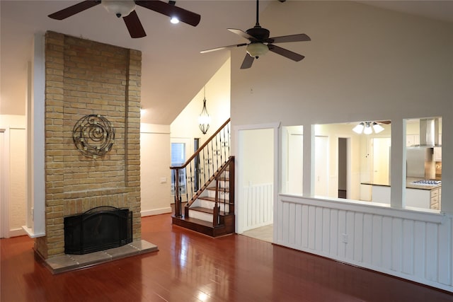 1035 Wirt Rd, Houston, TX 77055 - unfurnished living room with a brick fireplace, ceiling fan, wood finished floors, and high vaulted ceiling