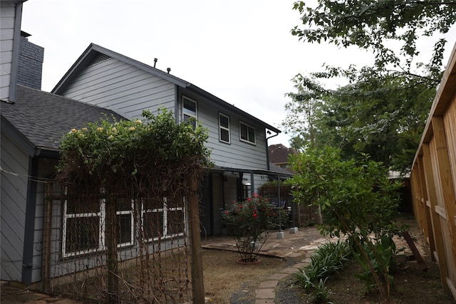1035 Wirt Rd, Houston, TX 77055 - view of side of home with fence, a patio area, and roof with shingles