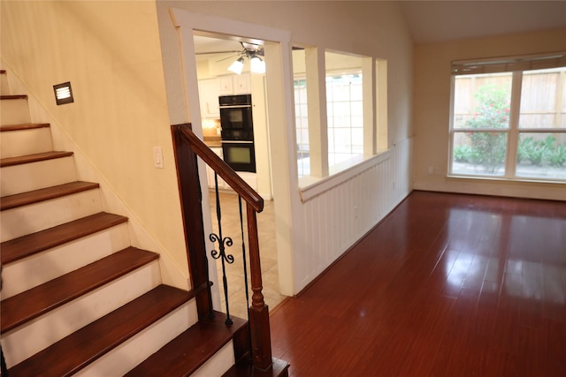 1035 Wirt Rd, Houston, TX 77055 - stairway featuring ceiling fan, vaulted ceiling, and wood finished floors