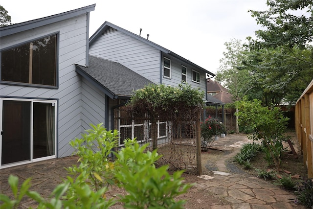 1035 Wirt Rd, Houston, TX 77055 - rear view of house with a shingled roof, a patio area, and fence