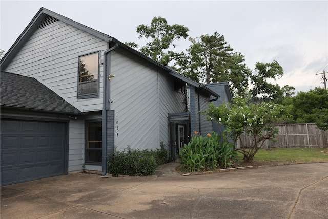 1035 Wirt Rd, Houston, TX 77055 - exterior space with fence, a shingled roof, driveway, and a garage