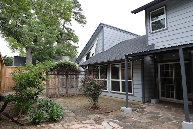 1035 Wirt Rd, Houston, TX 77055 - exterior space with fence, a patio, and a shingled roof