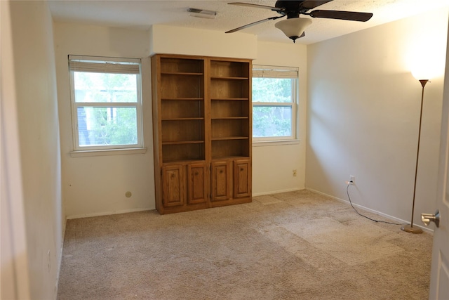 1035 Wirt Rd, Houston, TX 77055 - empty room featuring ceiling fan, light carpet, and a wealth of natural light