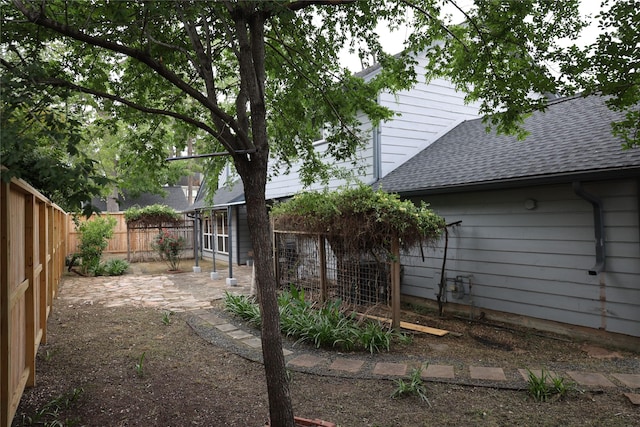 1035 Wirt Rd, Houston, TX 77055 - back of property featuring a fenced backyard, roof with shingles, and a patio area