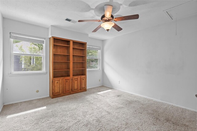 1035 Wirt Rd, Houston, TX 77055 - carpeted spare room featuring attic access, healthy amount of natural light, ceiling fan, and a textured ceiling