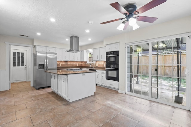 1035 Wirt Rd, Houston, TX 77055 - kitchen with appliances with stainless steel finishes, island exhaust hood, tasteful backsplash, dark countertops, and white cabinetry
