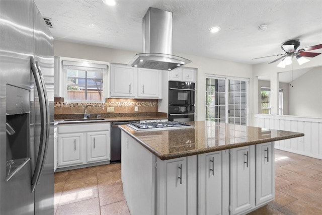 1035 Wirt Rd, Houston, TX 77055 - kitchen featuring stainless steel appliances, island exhaust hood, plenty of natural light, tasteful backsplash, and recessed lighting
