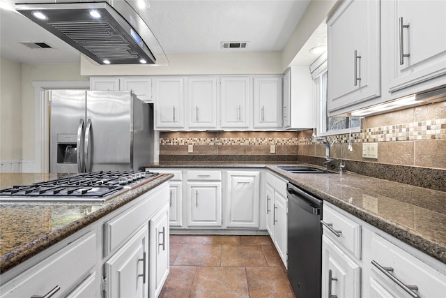 1035 Wirt Rd, Houston, TX 77055 - kitchen with stainless steel appliances, exhaust hood, white cabinets, dark stone counters, and tasteful backsplash