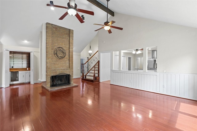 1035 Wirt Rd, Houston, TX 77055 - unfurnished living room with high vaulted ceiling, ceiling fan, a fireplace, beamed ceiling, and wood finished floors
