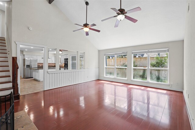 1035 Wirt Rd, Houston, TX 77055 - unfurnished living room with a ceiling fan, stairway, high vaulted ceiling, and wood finished floors