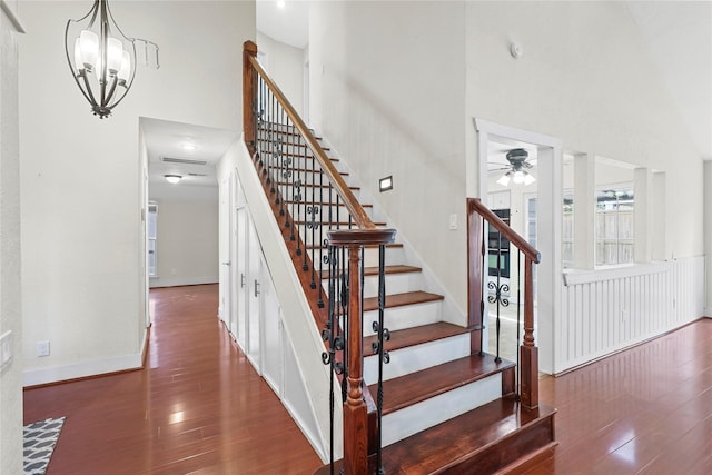 1035 Wirt Rd, Houston, TX 77055 - staircase with wood finished floors, a high ceiling, ceiling fan, and a chandelier