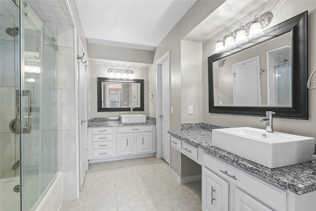 1035 Wirt Rd, Houston, TX 77055 - full bath with tile patterned floors, two vanities, and combined bath / shower with glass door