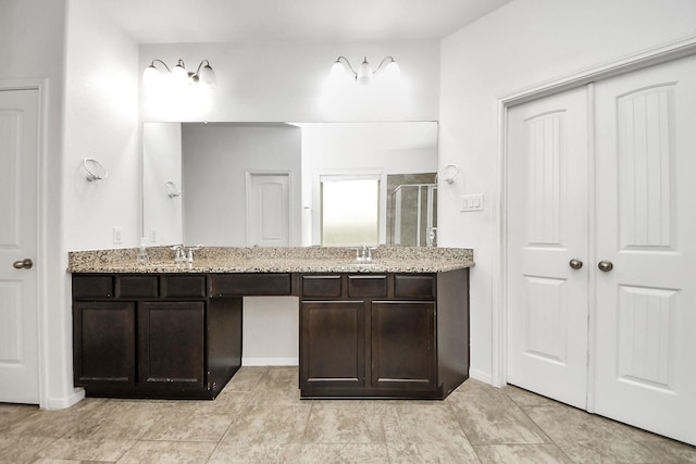 full bathroom with double vanity, a sink, and a shower stall