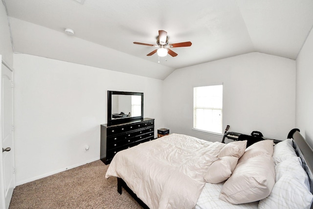 carpeted bedroom with baseboards, vaulted ceiling, and ceiling fan