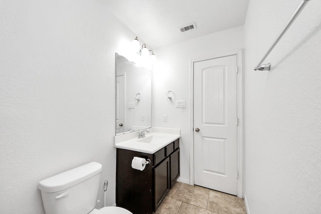 bathroom featuring visible vents, tile patterned flooring, toilet, and vanity