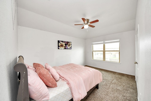 carpeted bedroom featuring a ceiling fan and baseboards