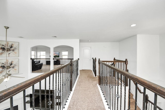 hallway with recessed lighting, an upstairs landing, carpet, and visible vents
