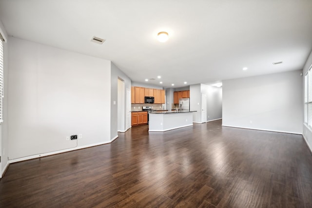 22507 Bellwick Ridge Ln, Katy, TX 77449 - unfurnished living room with baseboards, dark wood-style flooring, and recessed lighting