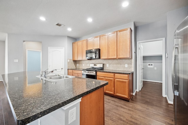22507 Bellwick Ridge Ln, Katy, TX 77449 - kitchen featuring a sink, stainless steel appliances, dark wood-type flooring, backsplash, and visible vents