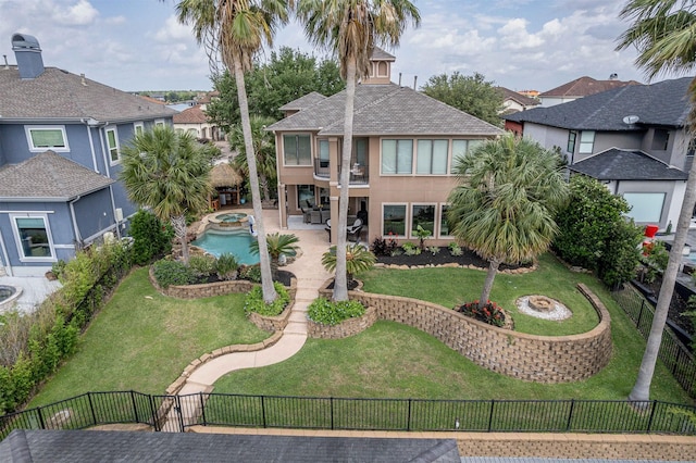 rear view of property featuring a patio, a fenced backyard, a lawn, an outdoor fire pit, and a residential view