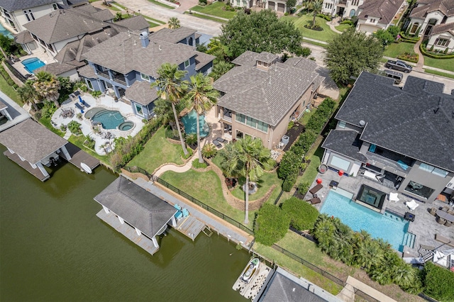 drone / aerial view featuring a residential view and a water view