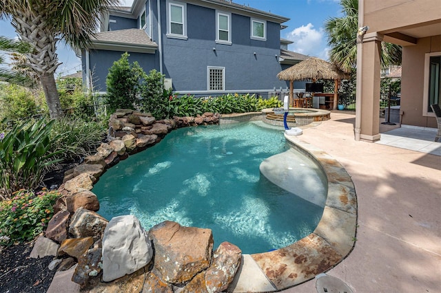 view of pool with a patio, a gazebo, fence, and a pool with connected hot tub