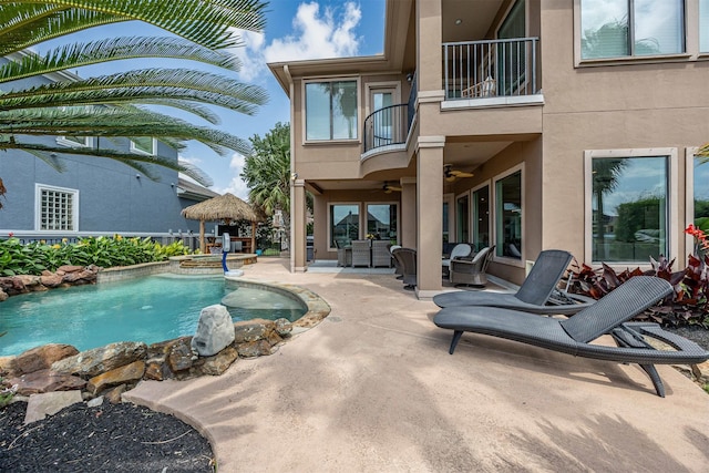 pool featuring a patio, a ceiling fan, and an outdoor living space