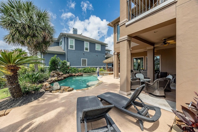 view of pool with a patio, ceiling fan, an outdoor living space, and a pool with connected hot tub