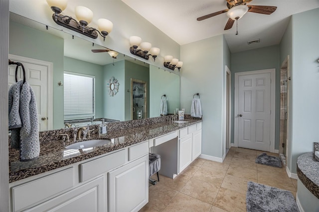 full bathroom with ceiling fan, tile patterned flooring, vanity, a shower stall, and visible vents