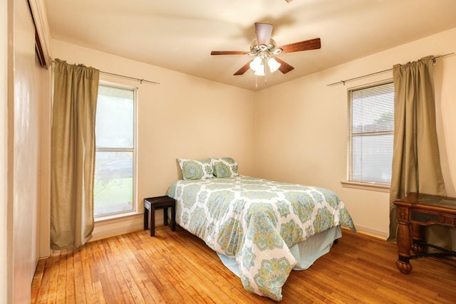 123 S Yaupon St, Lake Jackson, TX 77566 - bedroom with baseboards, multiple windows, and light wood-style flooring