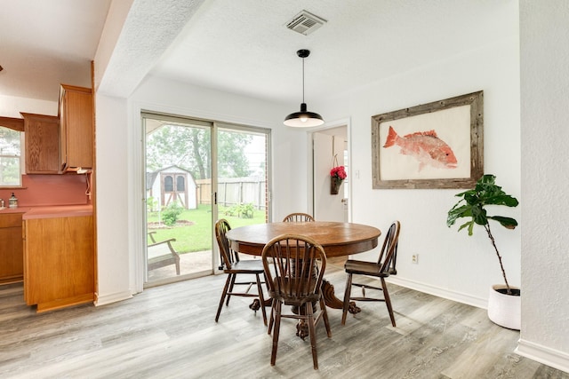 123 S Yaupon St, Lake Jackson, TX 77566 - dining area with baseboards, light wood-style flooring, and visible vents