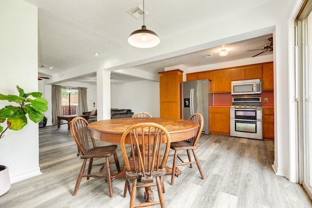 123 S Yaupon St, Lake Jackson, TX 77566 - dining room with visible vents, light wood finished floors, and ceiling fan